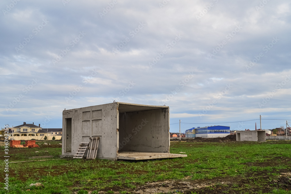 An abandoned concrete box in the field is used as a house An abandoned concrete box in the field is used as a house
