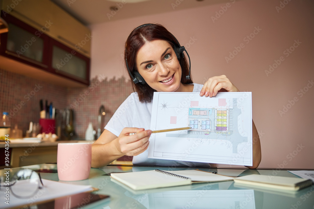 Employee indicating a specific place on a drawing Employee indicating a specific place on a drawing