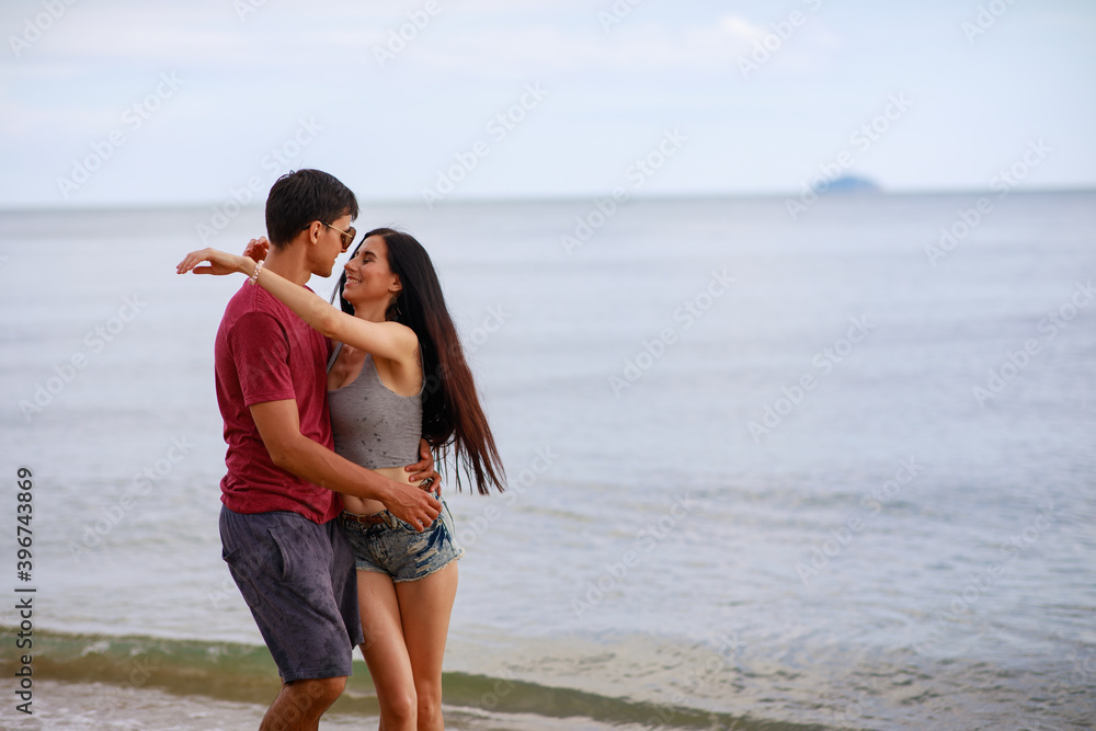 Happy young couple having fun at the beach . Happy young couple having fun at the beach .