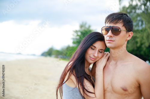 Happy young couple having fun at the beach .