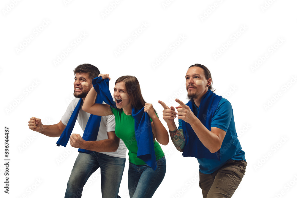 Teamwork and win. Female and male soccer fans cheering for favourite sport team with bright emotions isolated on white studio background. Looking excited, supporting. Concept of sport, fun, support. Teamwork and win. Female and male soccer fans cheering for favourite sport team with bright emotions isolated on white studio background. Looking excited, supporting. Concept of sport, fun, support.