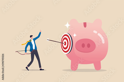 Financial goals, investment target, setting objective for retirement plan success concept, smart businessman investor or advisor shoot archer arrow hitting bull's eye target on saving pink piggy bank.