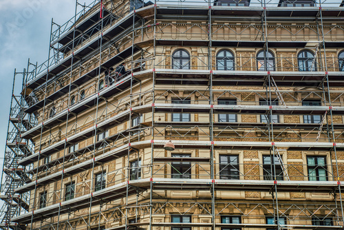Renovation or refurbishment work on a typical Danish building characterised by Dutch Renaissance architecture. Scaffolding is in place on the busy street of Norre Farimagsgade - Copenhagen, Denmark photo