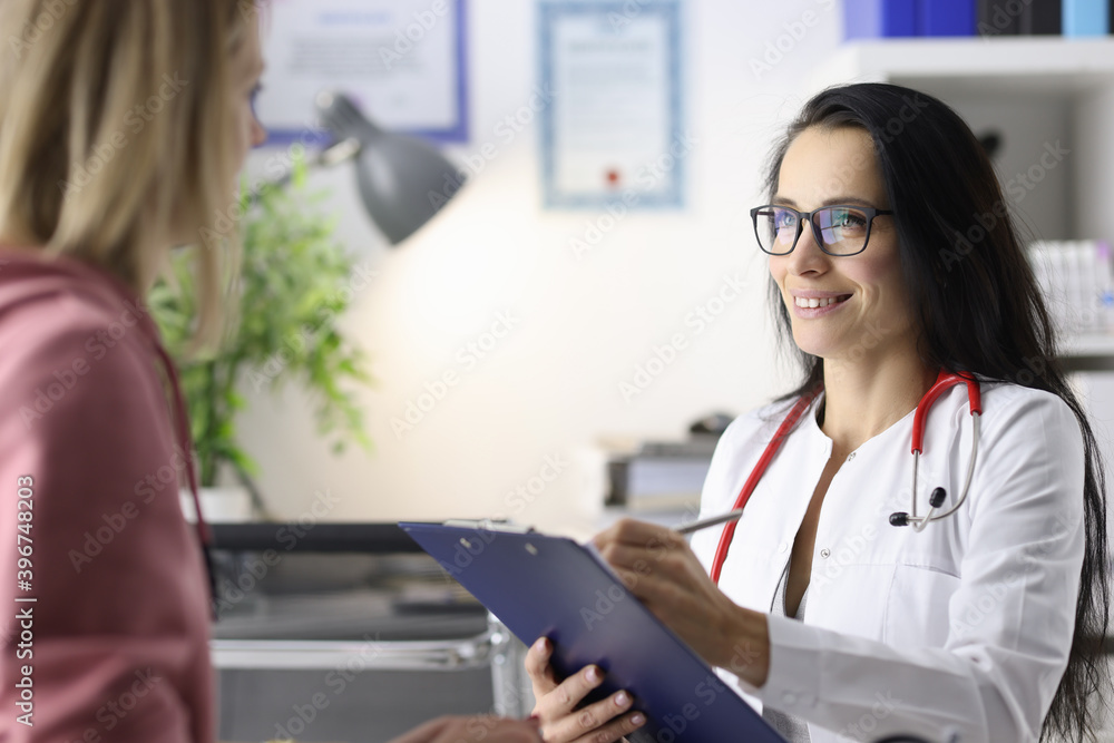Woman doctor conducts reception of patients in medical office. Woman doctor conducts reception of patients in medical office.