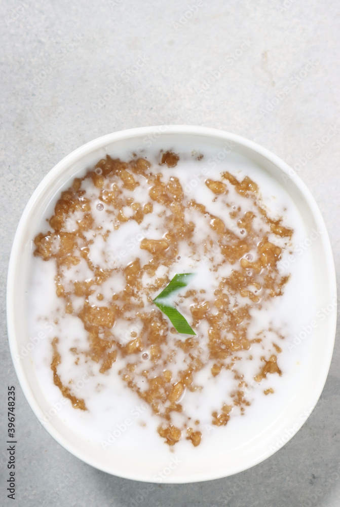 Jenang bubur abang or red brown sweet porridge with coconut milk. Cook and shared to neighbor for celebrate weton date birthday people from javanese culture. Jenang bubur abang or red brown sweet porridge with coconut milk. Cook and shared to neighbor for celebrate weton date birthday people from javanese culture.
