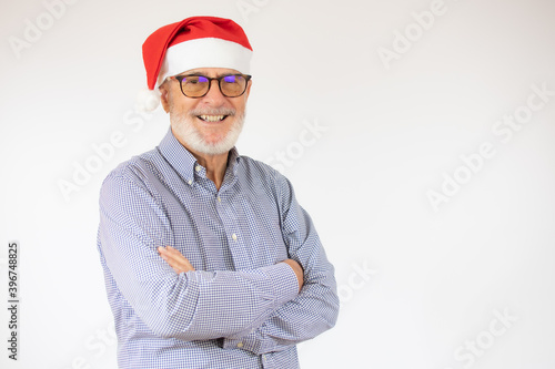 happy cheerful man in santa hat with arm crossed rejoicing at his retirement. Christmas concept.