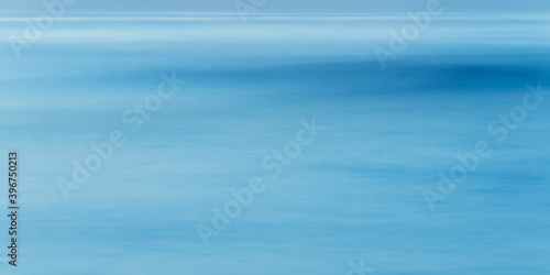 Long exposure of sea water and wave, full frame blue abstract background, shot at blue hour
