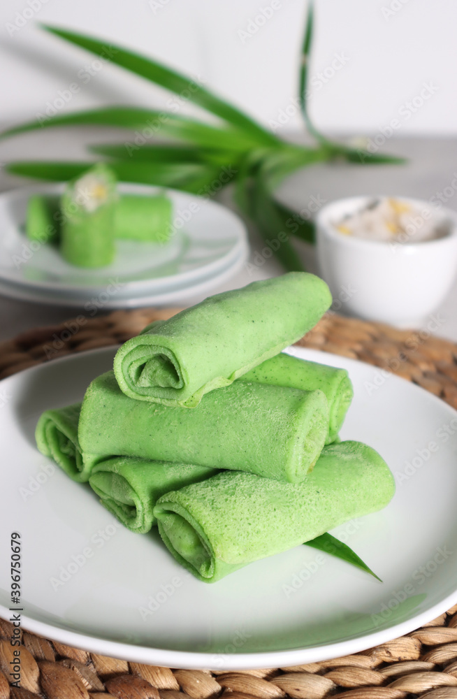 Dadar Gulung or Dadar Unti is Indonesian traditional finger food (jajan pasar), is grated coconut sweetened with palm sugar wrapped in pandan crepes. Dadar Gulung or Dadar Unti is Indonesian traditional finger food (jajan pasar), is grated coconut sweetened with palm sugar wrapped in pandan crepes.