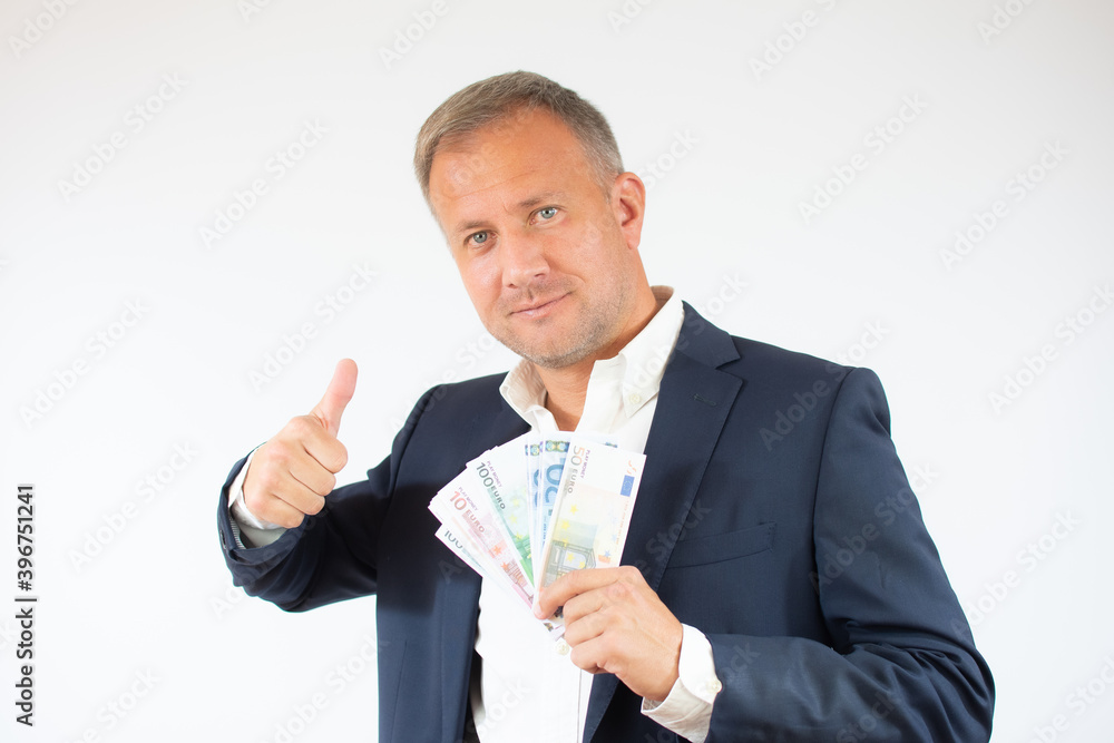 Happy businessman holding money and thumb up sign on white background Happy businessman holding money and thumb up sign on white background