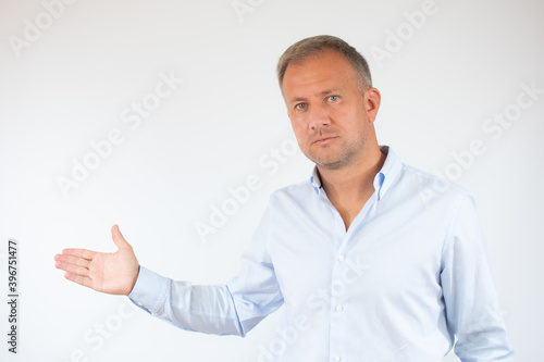 Man in casual shirt pointing space over white background © Danko