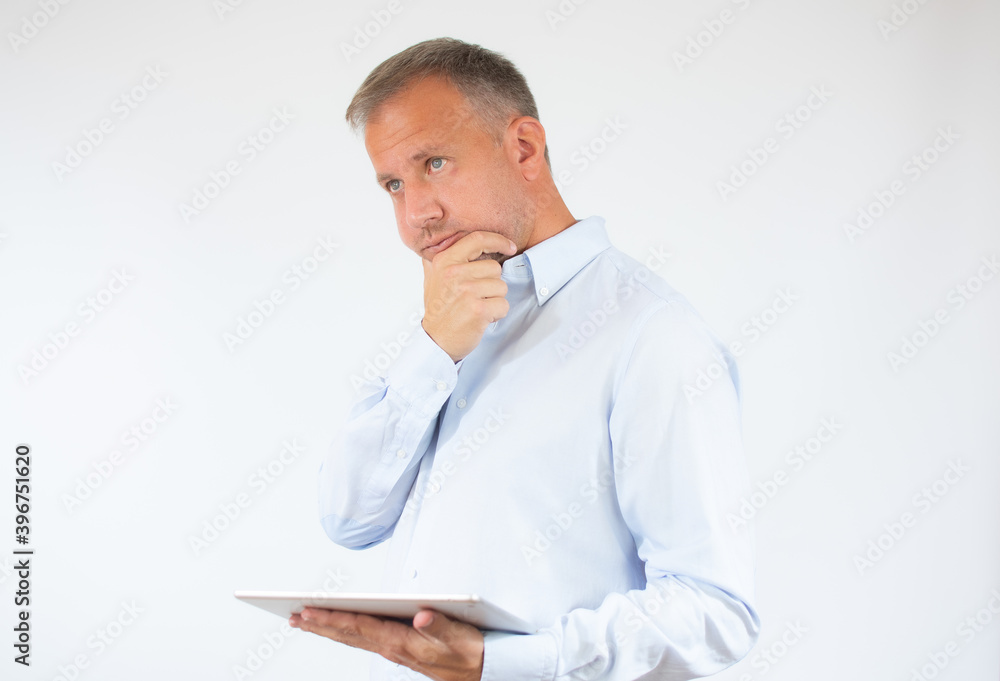 Young man in casual shirt using digital tablet isolated on white background Young man in casual shirt using digital tablet isolated on white background