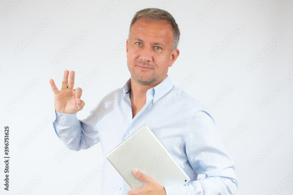 Happy young man in casual shirt using digital tablet isolated on white background Happy young man in casual shirt using digital tablet isolated on white background