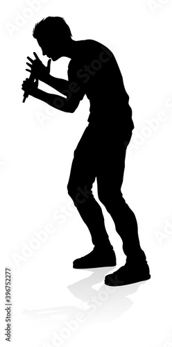 A singer pop  country music  rock star or hiphop rapper artist vocalist singing in silhouette