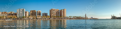 Panorama of "Palmeral de las sorpresas". an architectural structure in the the promenade of the port of Malaga. "Muelle Uno" shopping mall,Malagueta buildings, main park and La Farola lighthouse © elroce