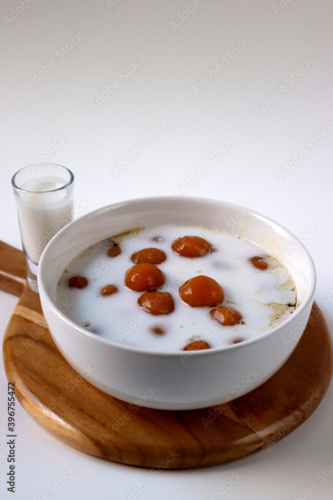 Biji Salak or Candil Ubi, Indonesian porridge with sweet potato glutinous rice balls, served with palm sugar sauce & coconut milk. An Indonesian typical refreshment and dessert during Ramadan month. Biji Salak or Candil Ubi, Indonesian porridge with sweet potato glutinous rice balls, served with palm sugar sauce & coconut milk. An Indonesian typical refreshment and dessert during Ramadan month.
