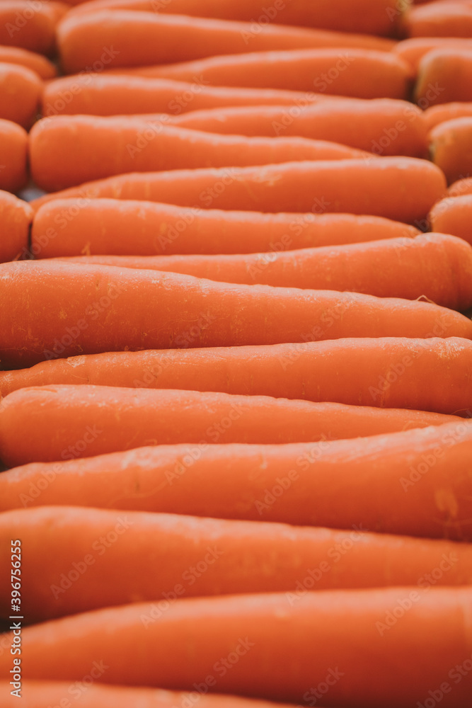 Close up view of organic carrots as background at the market. Vegetarian food concept. Close up view of organic carrots as background at the market. Vegetarian food concept.