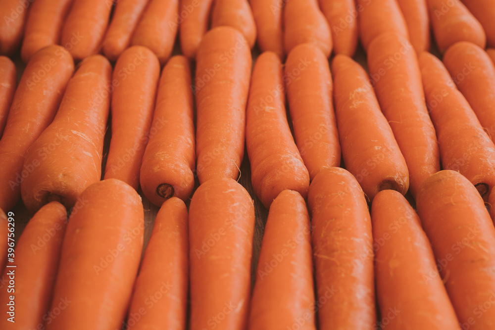 Close up view of organic carrots as background at the market. Vegetarian food concept. Close up view of organic carrots as background at the market. Vegetarian food concept.