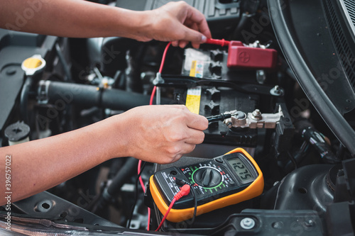 Technician Hands of  Maintenance car battery. © Maderla