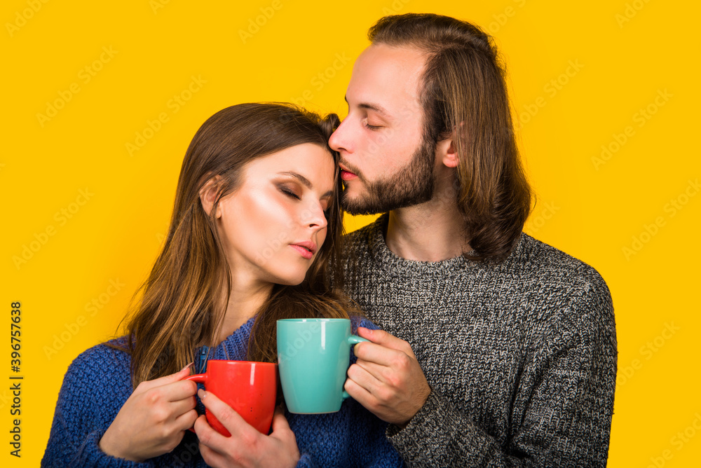 Winter. Cold weather. Couple in warm clothes. Cup with tea. Hot drink. Woman in warm clothes holds cup of tea. Happy couple. Winter. Cold weather. Couple in warm clothes. Cup with tea. Hot drink. Woman in warm clothes holds cup of tea. Happy couple.