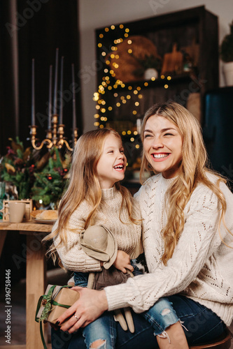 Portrait of happy family, mother and daughte celebrate Christmas in living room