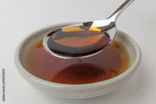 Anchovy fish sauce on white background photo