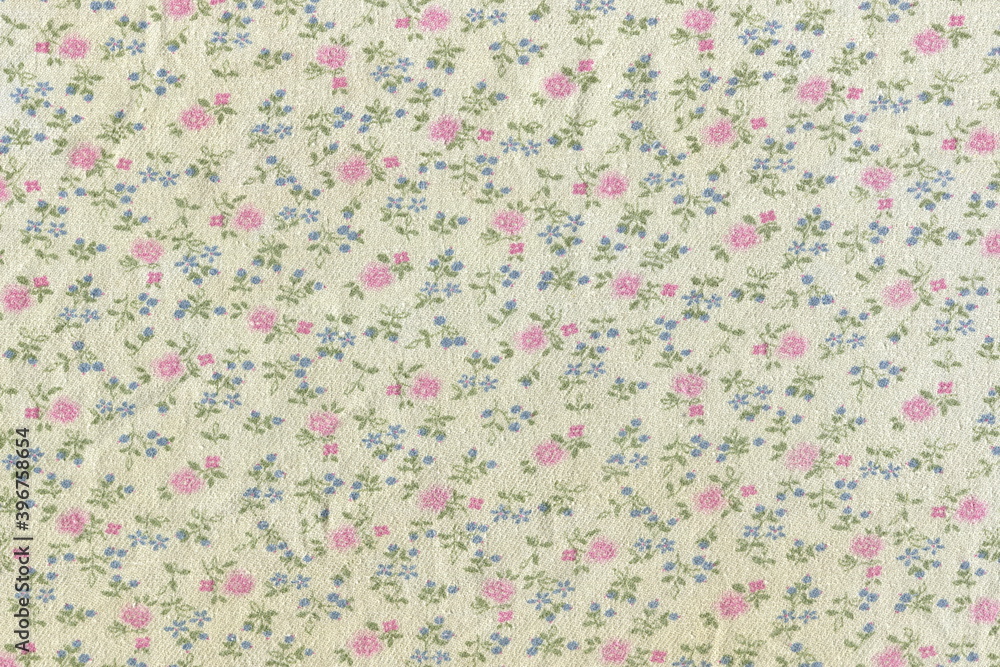 Texture of cotton fabric in a small flower. Abstract background of simple rural fabric. Rough natural fabric with a pattern.