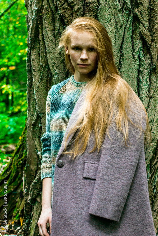 portrait of a ginger young woman in forest portrait of a ginger young woman in forest
