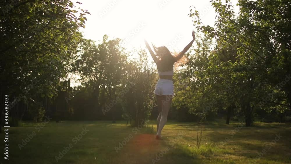 Happy Young Woman Spinning In The Summer Garden Happy Young Woman Spinning In The Summer Garden