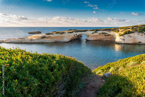 Limestone rock with arch, S'`Archittu di Santa Caterina in Oristano Province, Sardinia, Italy photo