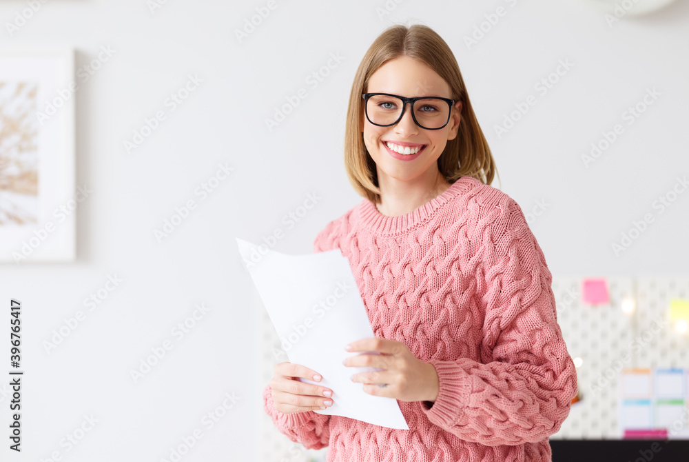 Happy female freelancer with document at home. Happy female freelancer with document at home.