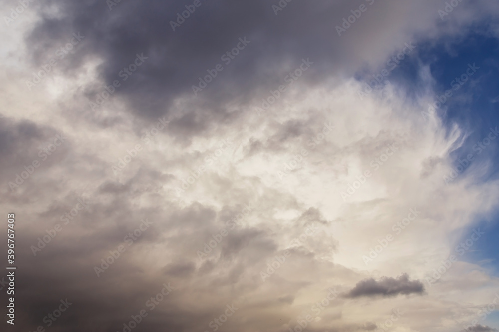 Storm sky, dark and white big cumulus clouds on blue sky background texture