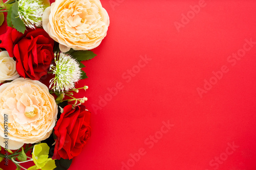 Floral frame on red background with copy space. Roses, peonny spring plants photo