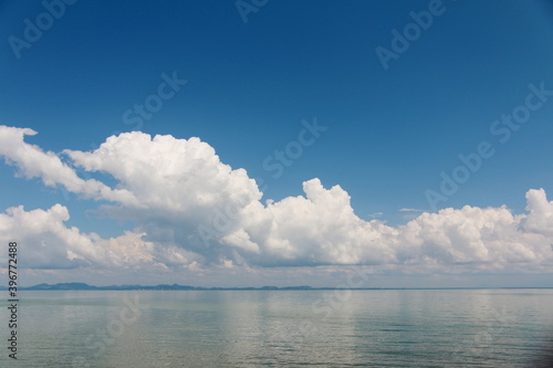 Bright sky with white clouds above the sea, for background.