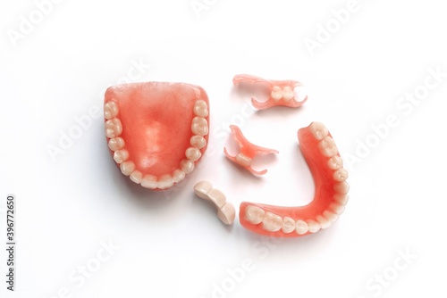 Dental prosthetics on a white background. Dentures. Prosthetic teeth. False teeth. Prosthetic dentistry. Set of dentures on a white background. Top view of complete denture on white background
