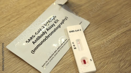 Review of a negative covid 19 blood test. Sars-cov-2 negative on top of the SARS-cov-2 Antibody assay kit package. Negative test results on COVID-19 virus. photo