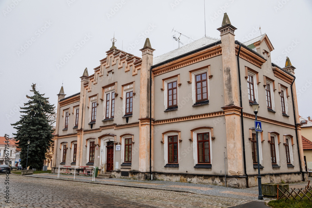 Historical neo renaissance primary school building at main town Husovo Square at cloudy autumn day, Cesky Brod, Central Bohemia, Czech Republic