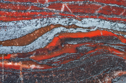 Full-screen texture of red ferruginous quartzite (jaspillite) rock. Natural stone background.