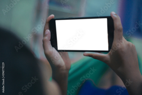 a little boy holding a smartphone