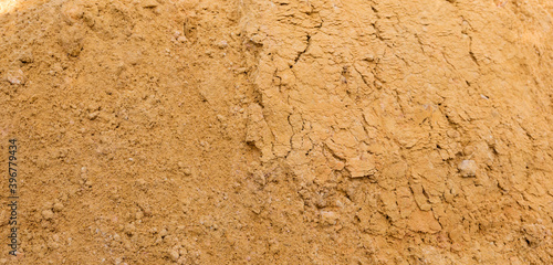 River sand, flat surface of yellow quartz wet sand in a quarry.