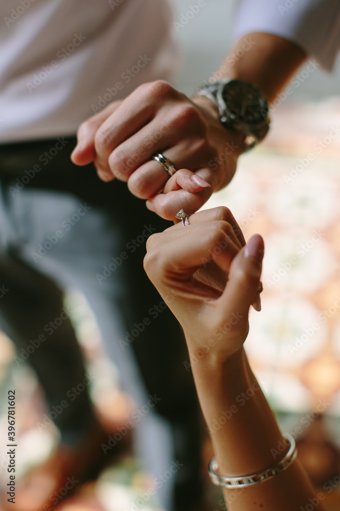 Fototapeta premium Close up on a couple holding fingers