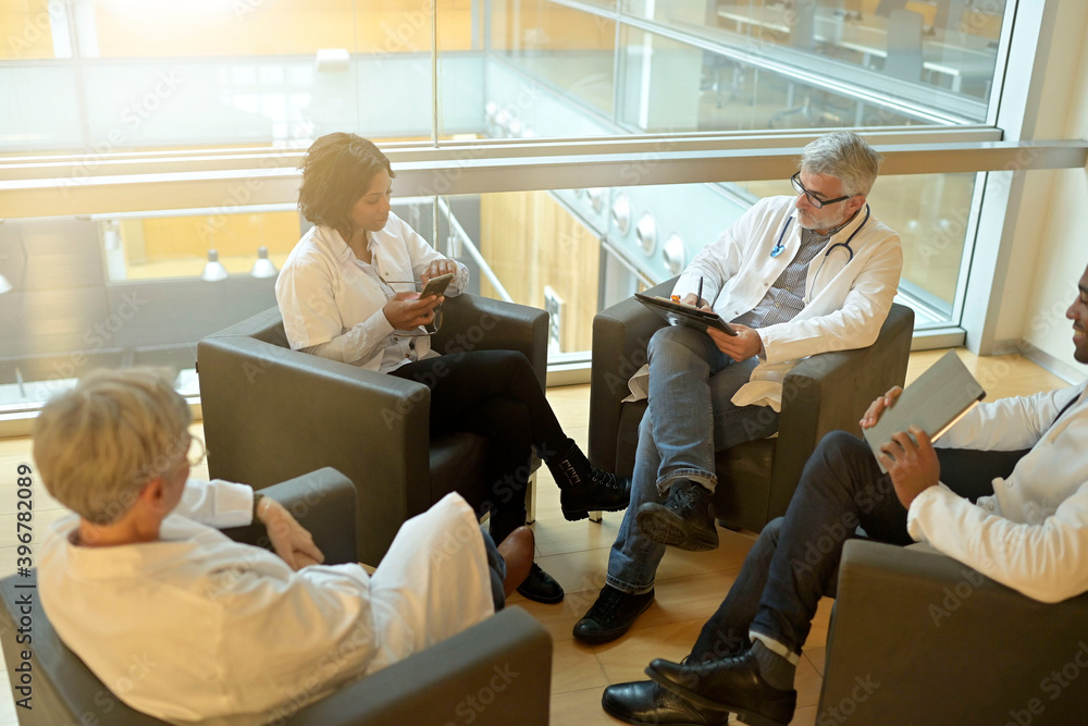 Medical people sitting in meeting room, checking planning together Medical people sitting in meeting room, checking planning together