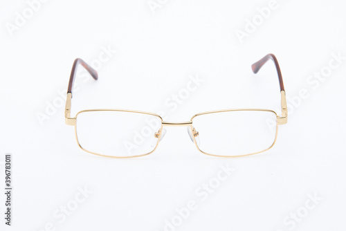 Fashion sunglasses golden frames on white background.