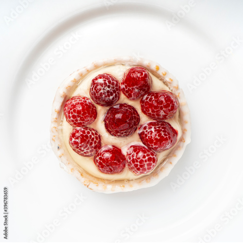 Tasty tartlet cake with raspberries and cream. Top view.