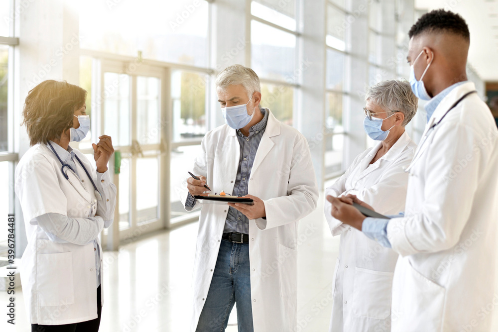 Group of doctors meeting in hospital for instructions and medical report during 19-ncov pandemic Group of doctors meeting in hospital for instructions and medical report during 19-ncov pandemic