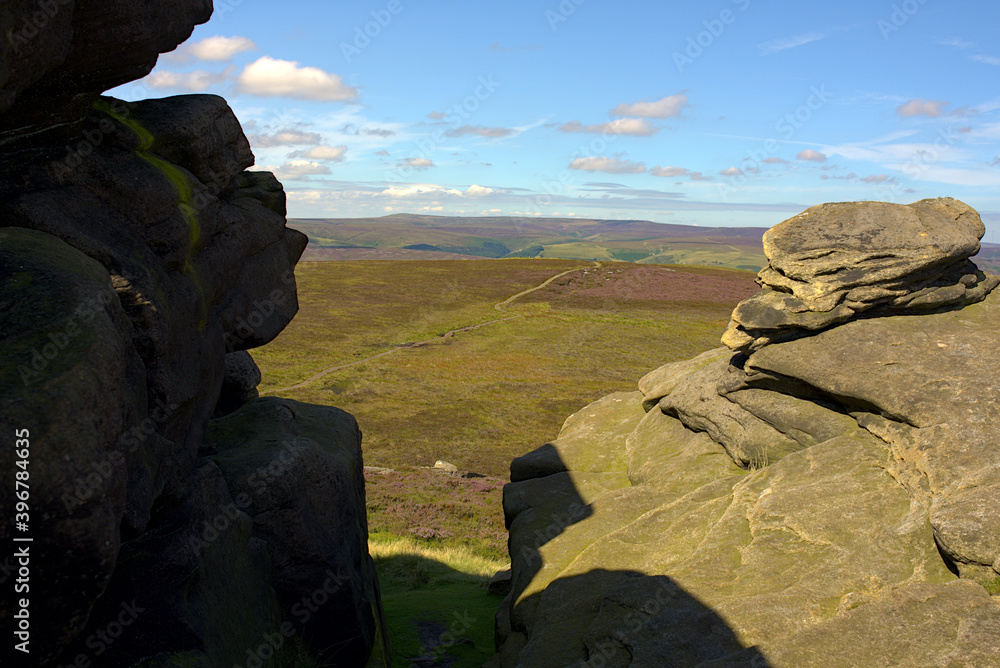 view from the top of a British mountain between boulders