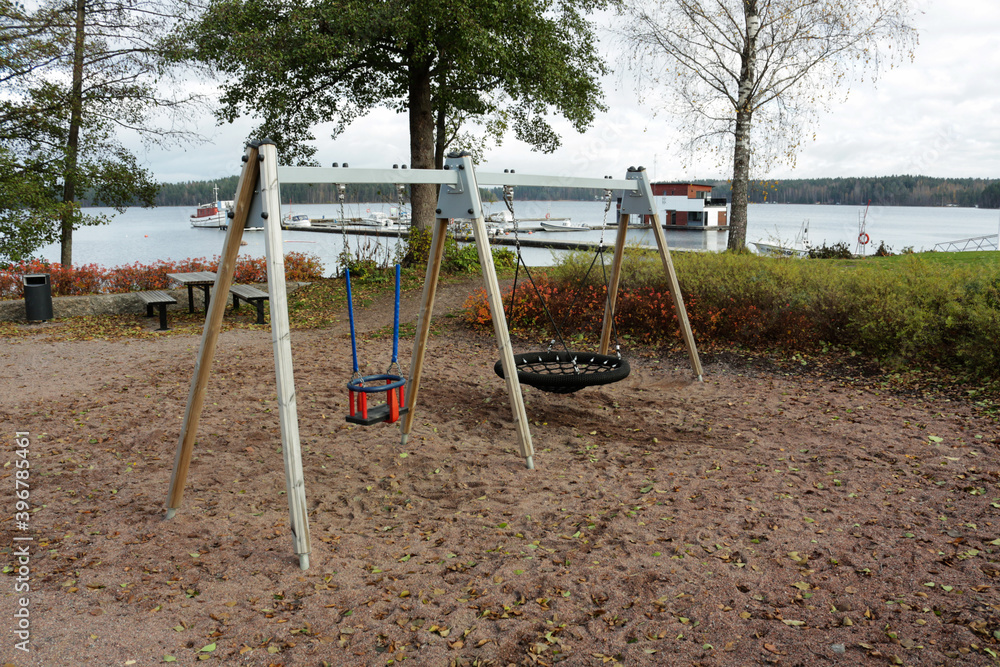 Swing on the playground by the lake