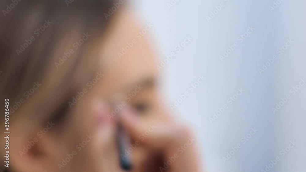 Young brunette woman make-up artist paints a blonde girl in a beauty salon. Eyeshadows. Young brunette woman make-up artist paints a blonde girl in a beauty salon. Eyeshadows.