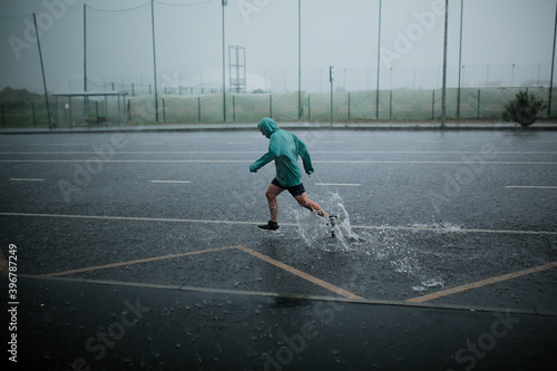man runs in the rain
