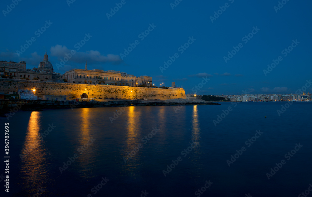 Panoramic view of Valletta, Malta with blurry sea in the foreground. Special blurry artistic motion. Sunset in Malta