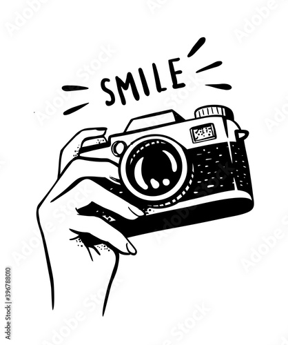 female hand holding camera on white background